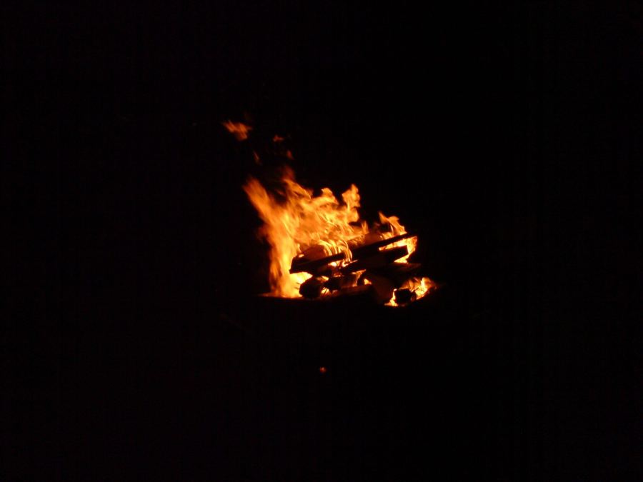 A wood fire burning in the dark